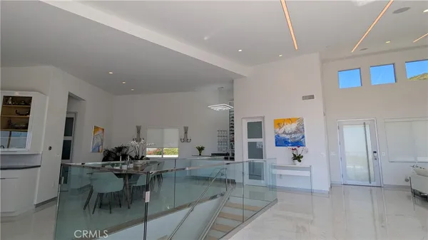 a living room with furniture and a dining table