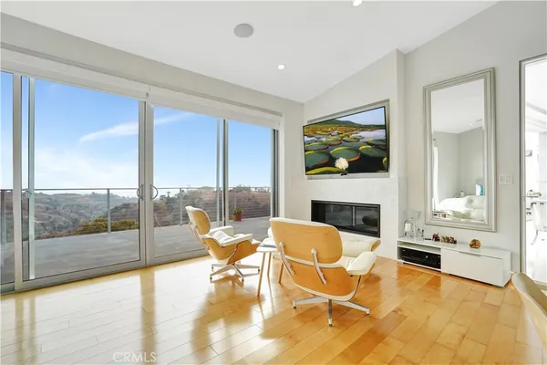 a living room with fireplace furniture and a large window