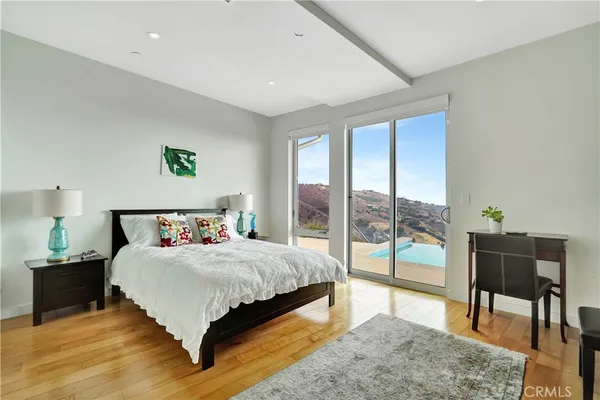 a bedroom with a bed and a large window