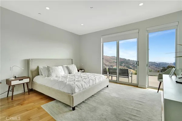 a bedroom with a large bed and a large window