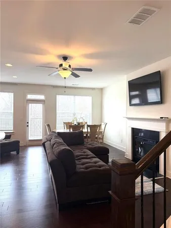 a living room with fireplace furniture and a flat screen tv