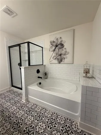 a bathroom with a bathtub and a shower