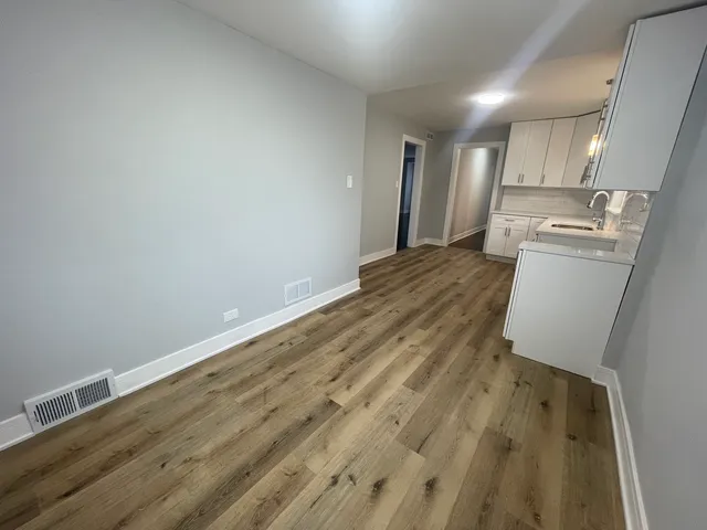 a view of a kitchen with wooden floor