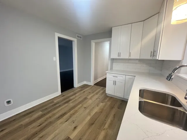 a kitchen with a sink a stove and cabinets