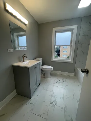 a bathroom with a sink toilet and mirror