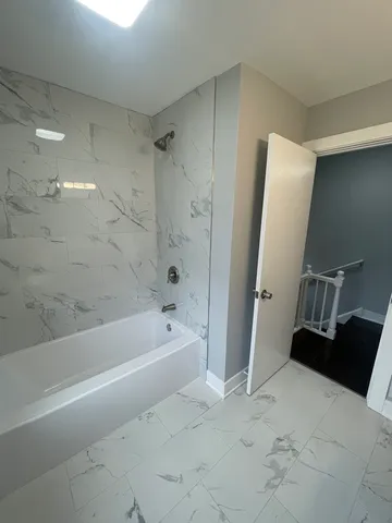 a spacious bathroom with a bathtub and a shower