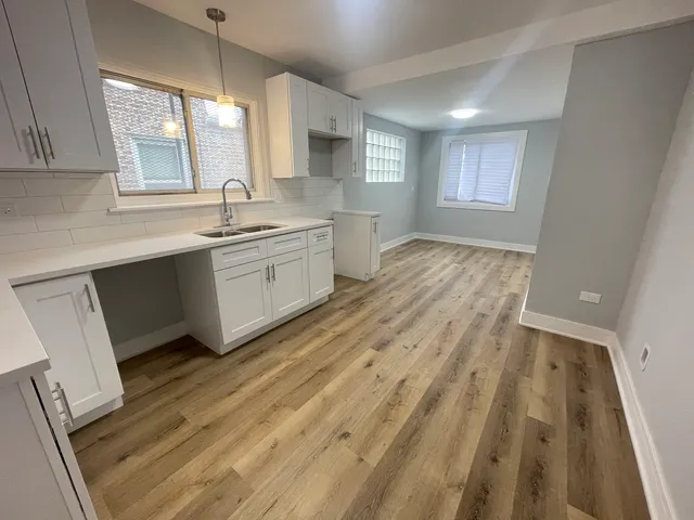 a spacious bathroom with a sink mirror and a bathtub
