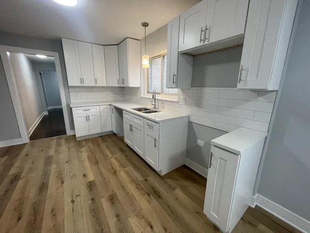 a kitchen with a sink stove and cabinets