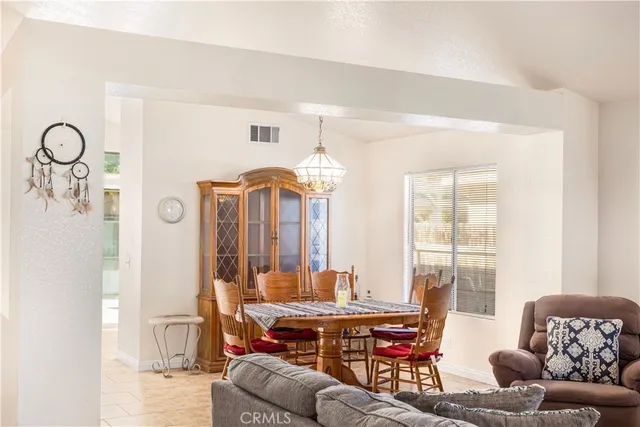 a living room with furniture a table and a chandelier
