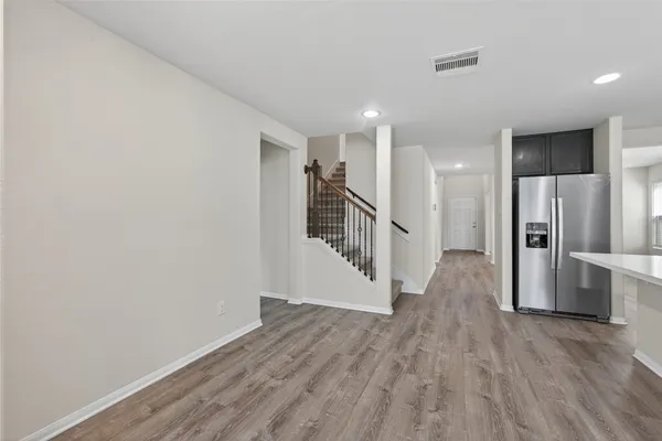 a view of a hallway with wooden floor