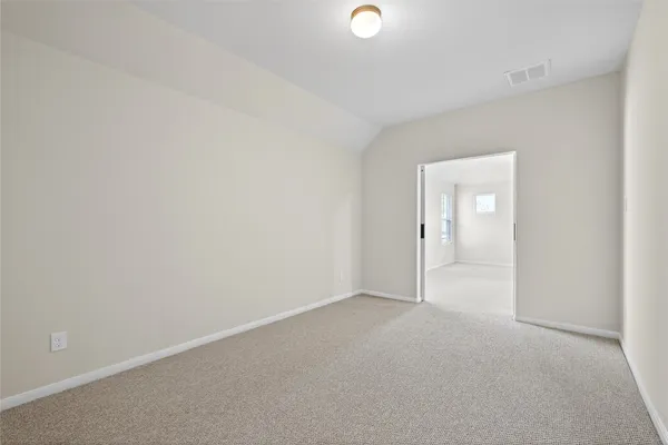 a view of a hallway with closet and a fireplace