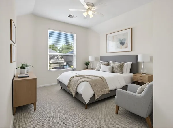 an empty room with a window and ceiling fan