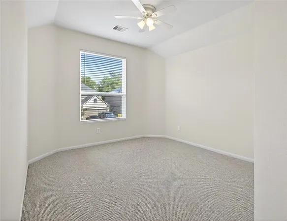 an empty room with a chandelier fan