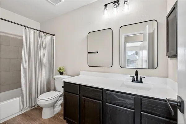 a bedroom with a bed and ceiling fan