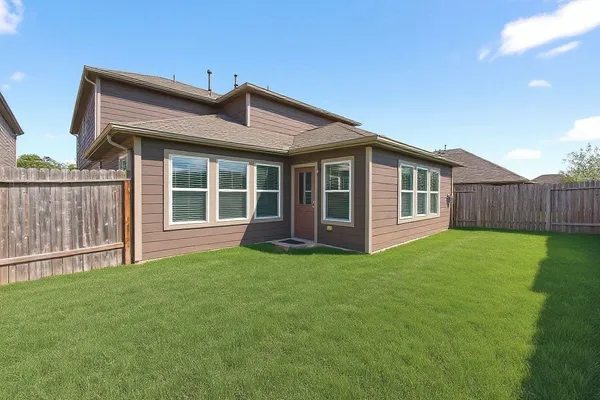 a view of a house with a backyard