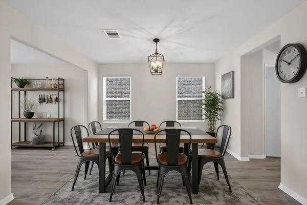 a view of a dining room with furniture and window
