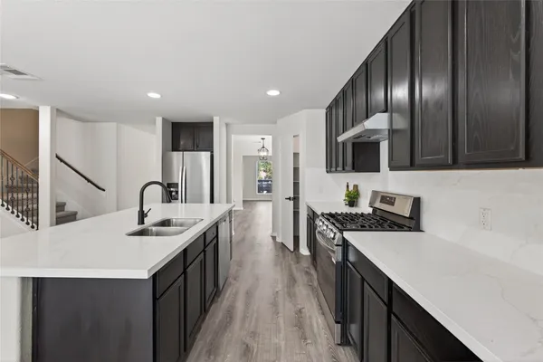 a kitchen that has a sink and a stove in it