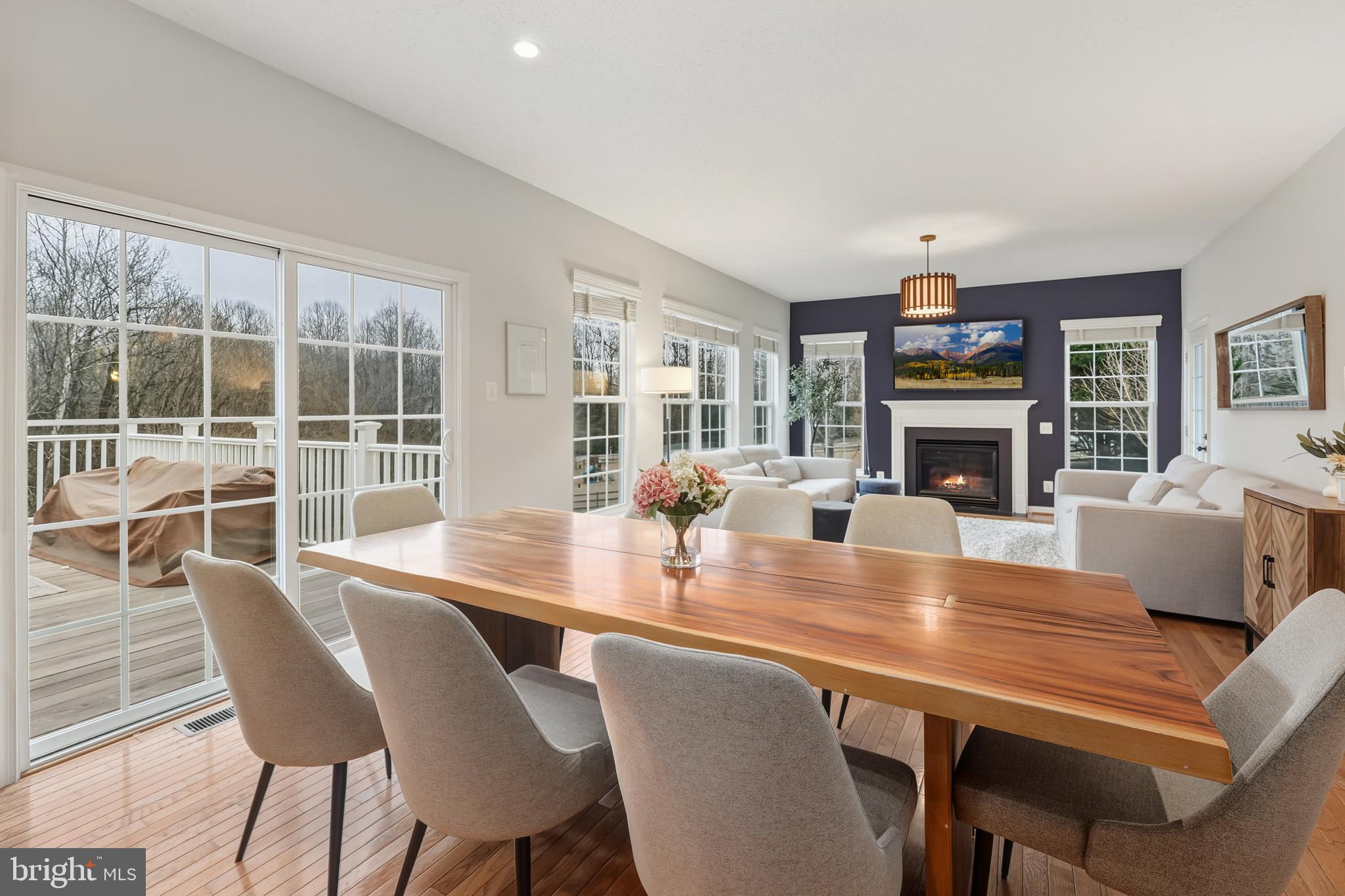8439 Den Circle King George, VA 22485 - Photo 12 of 53 a dining room with furniture a fireplace and wooden floor