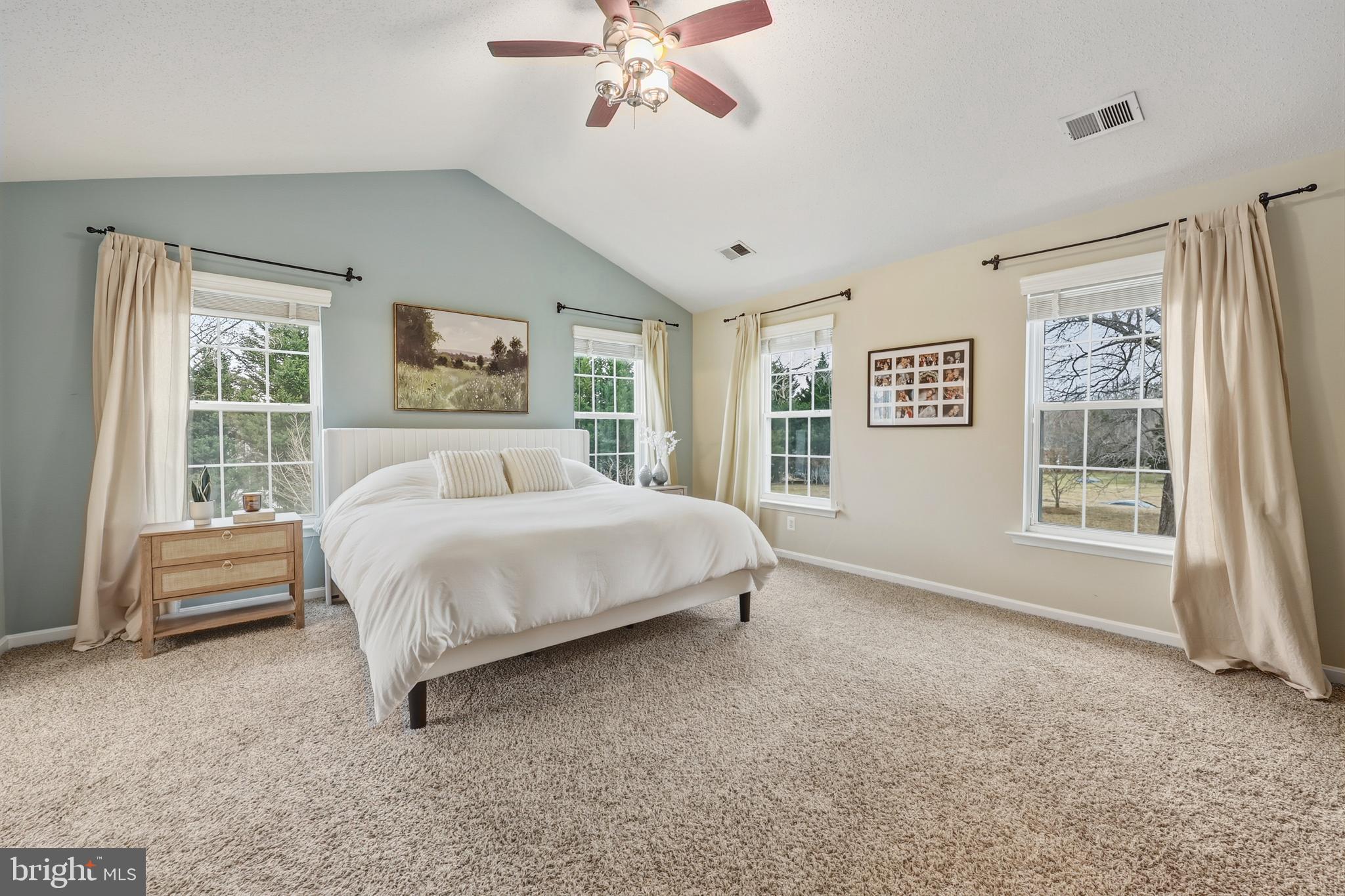 8439 Den Circle King George, VA 22485 - Photo 18 of 53 a spacious bedroom with a bed a couch and a window