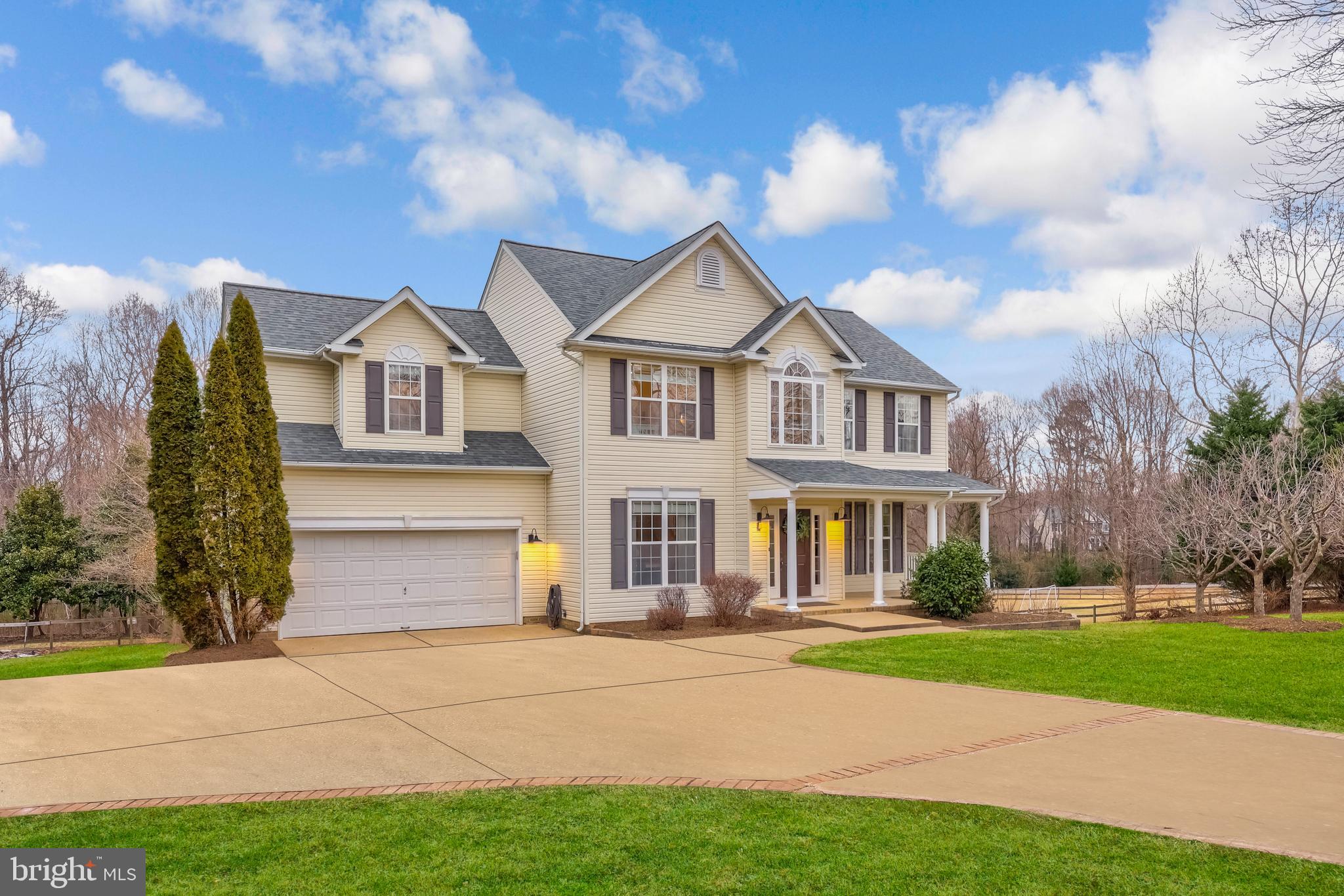 8439 Den Circle King George, VA 22485 - Photo 2 of 53 a front view of a house with a garden and trees