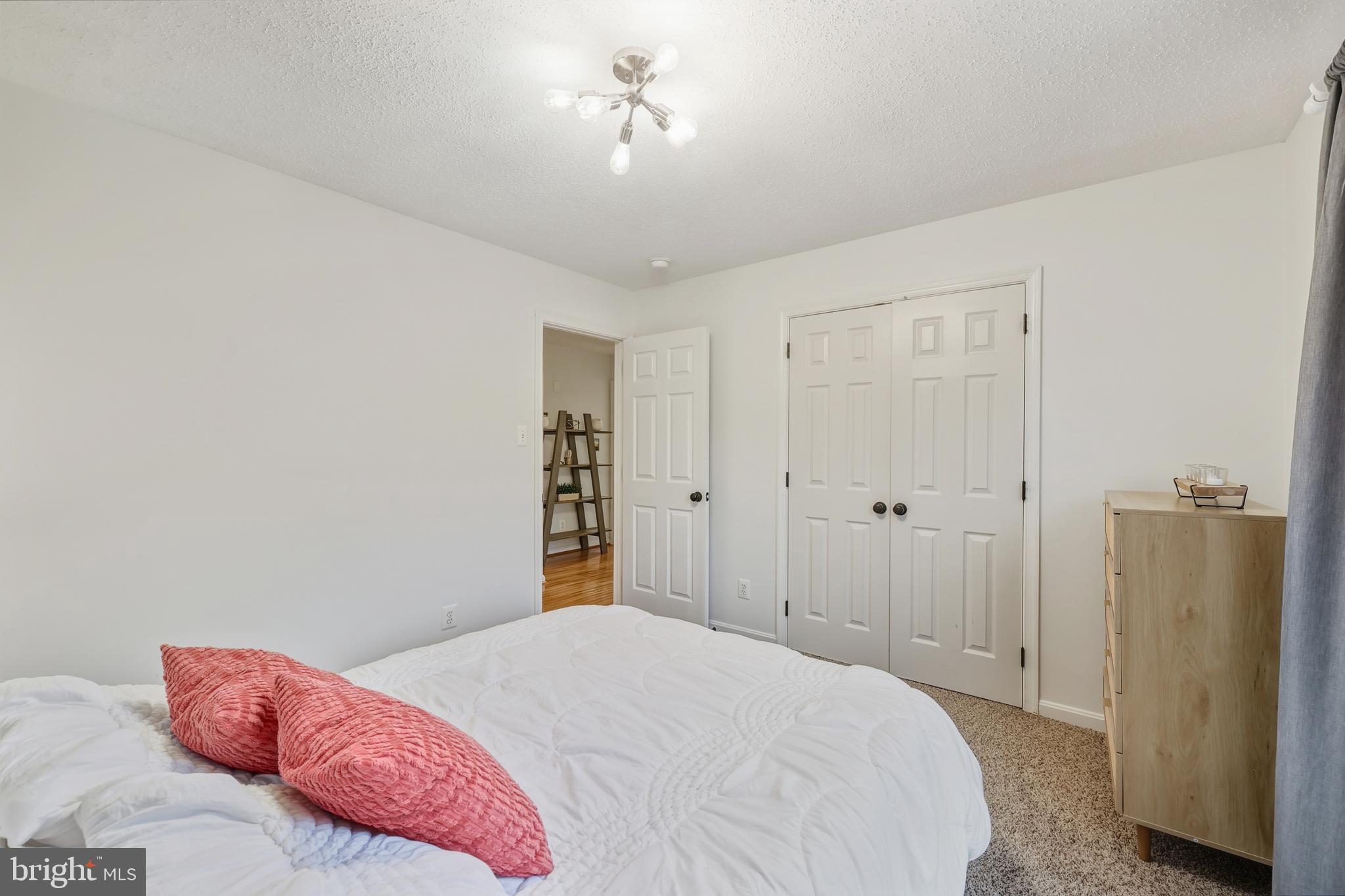 8439 Den Circle King George, VA 22485 - Photo 27 of 53 a bedroom with a bed and a chandelier
