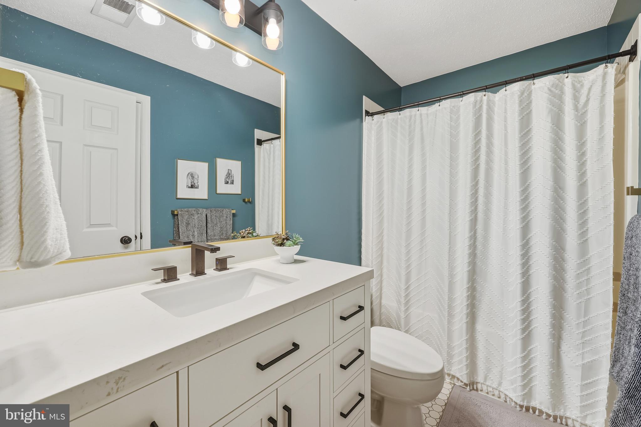 8439 Den Circle King George, VA 22485 - Photo 29 of 53 a bathroom with a sink toilet and a mirror