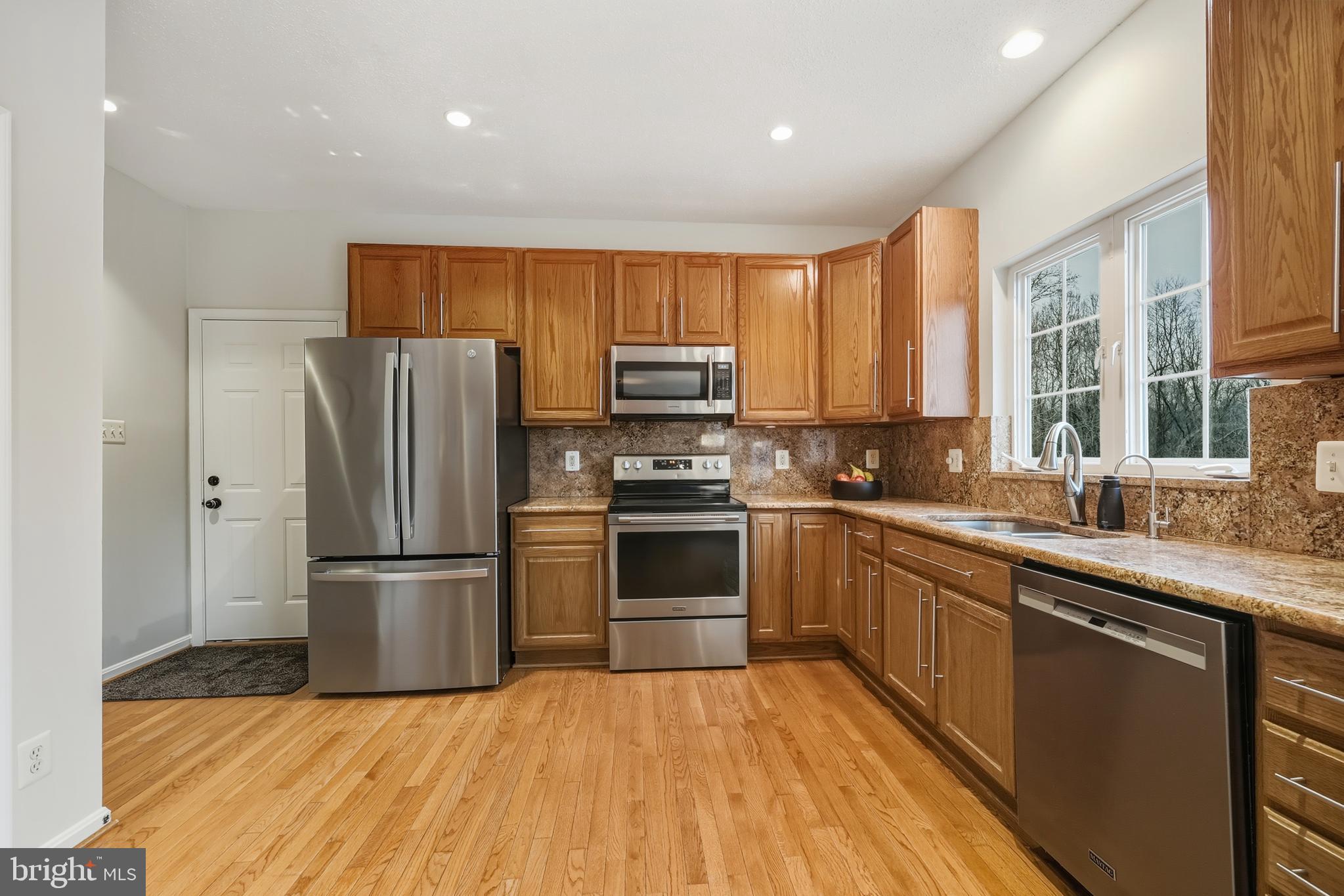 8439 Den Circle King George, VA 22485 - Photo 9 of 53 a kitchen with a refrigerator and a sink
