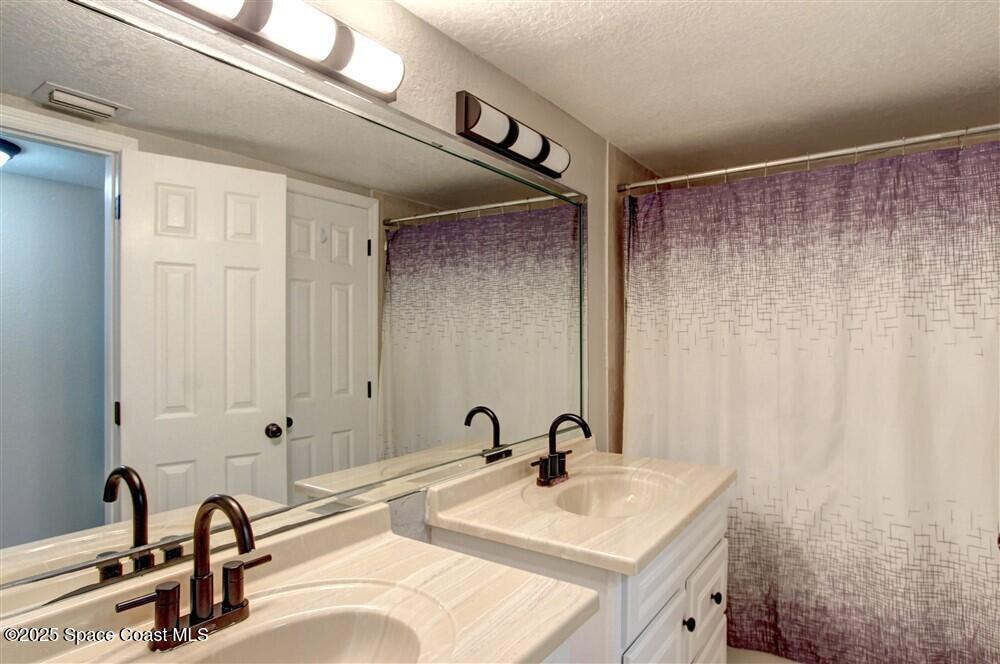 130 Roosevelt Avenue, Unit 104 Satellite Beach, FL 32937 - Photo 15 of 21 a bathroom with a sink and a mirror