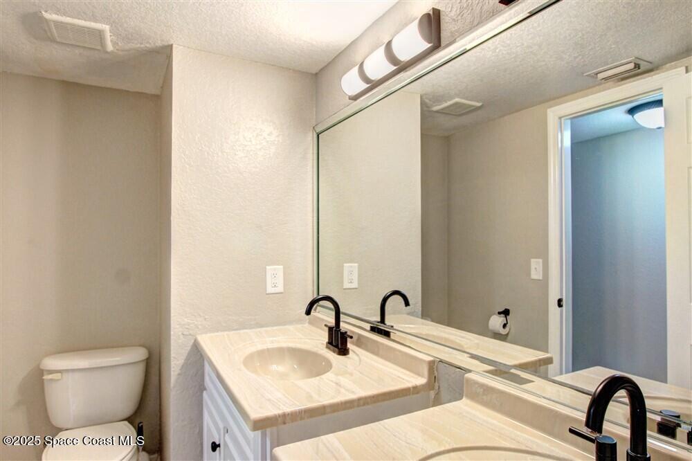 130 Roosevelt Avenue, Unit 104 Satellite Beach, FL 32937 - Photo 16 of 21 a bathroom with a sink and a mirror
