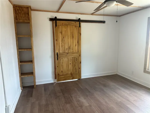 an empty room with wooden floor