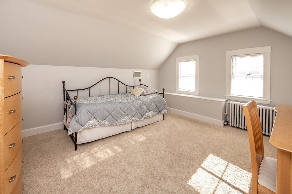 64 Garland Road Newton, MA 02459 - Photo 24 of 27 a spacious bedroom with a bed and a couch