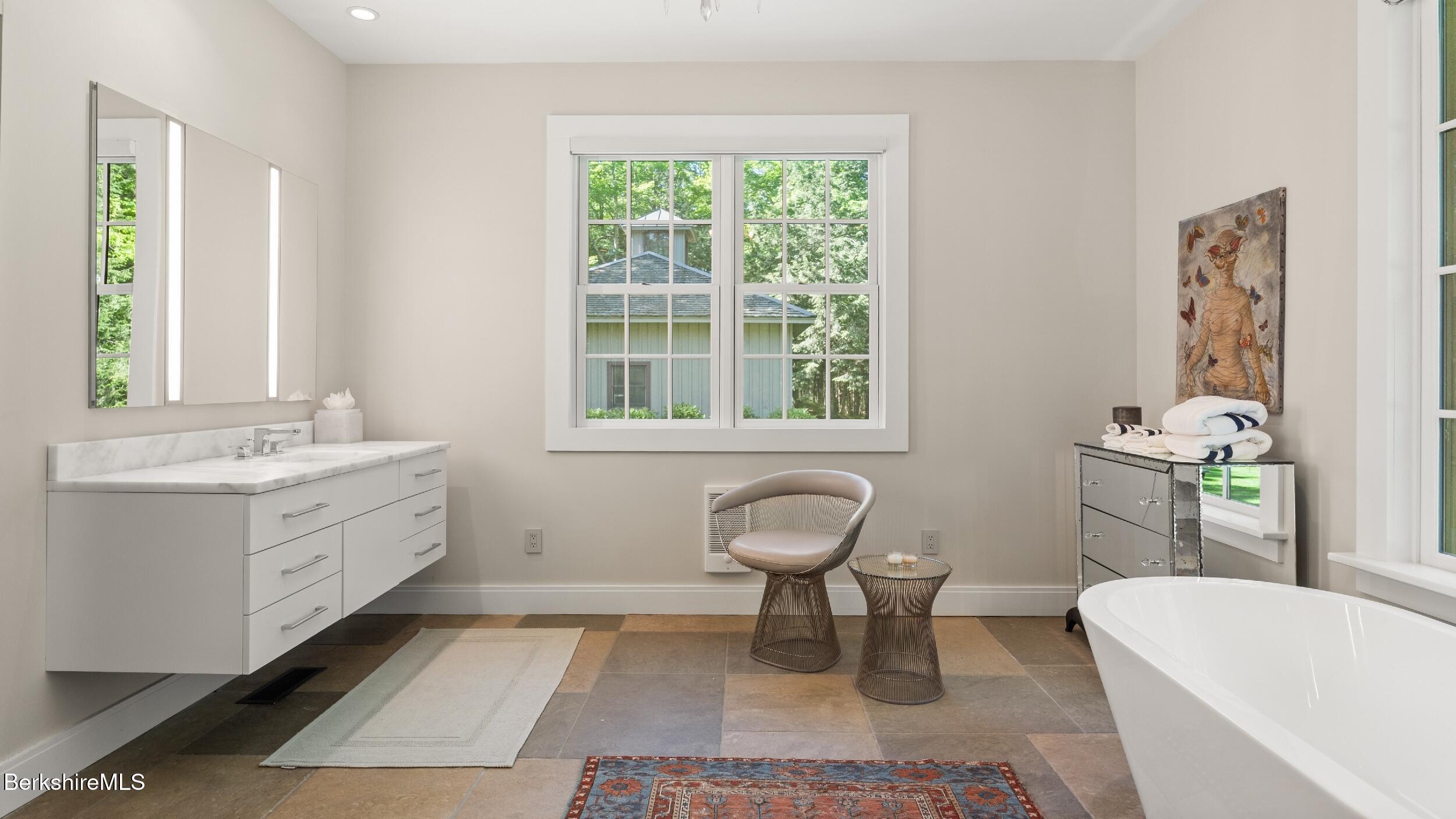 232 Giberson Road Sheffield, MA 01257 - Photo 19 of 53 a spacious bathroom with a double vanity sink a toilet and a tub