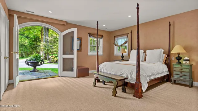 a bedroom with two beds and a large window