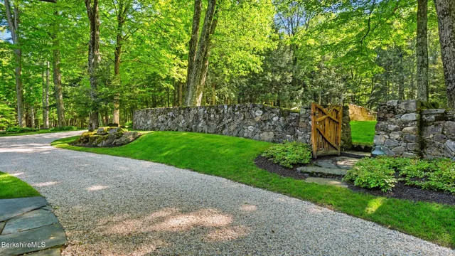 a backyard of a house with yard and outdoor seating