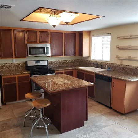 a kitchen with a stove a sink and a microwave