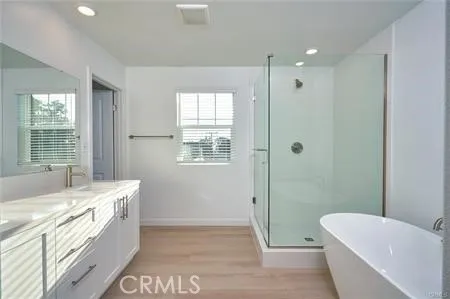 a bathroom with a tub sink and mirror