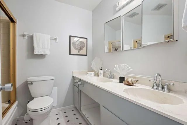 a bathroom with a toilet sink and mirror
