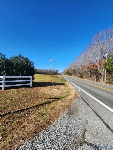 a view of a yard with wooden fence