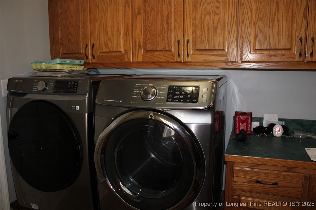 573 Porter Road Hope Mills, NC 28348 - Photo 11 of 29 a close view of a storage and utility room with washer and dryer
