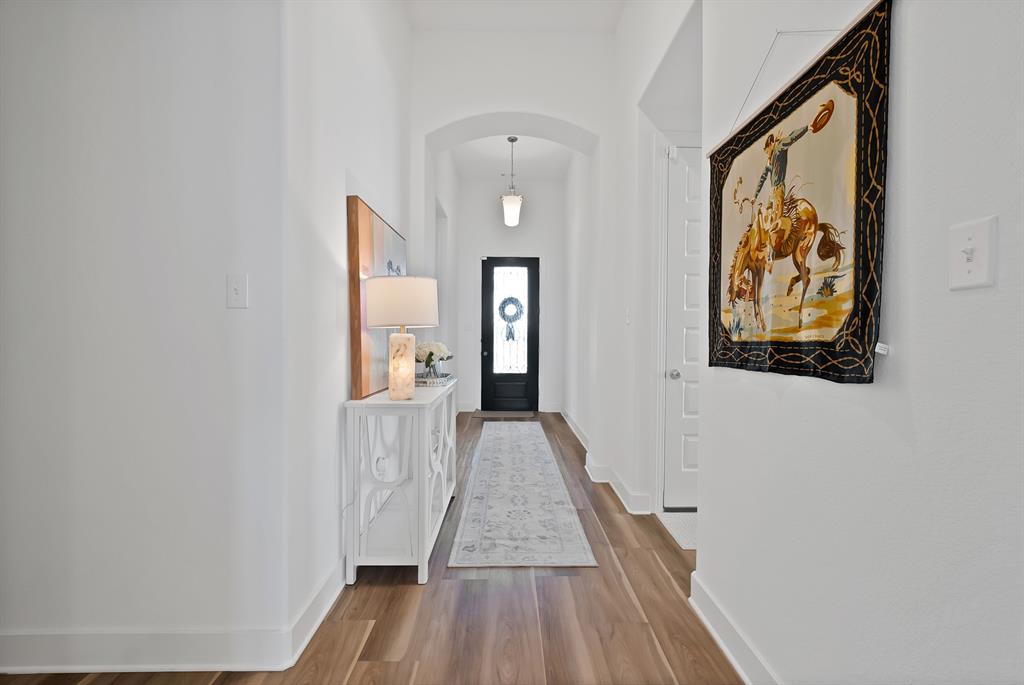 1709 Shetland Road Aubrey, TX 76227 - Photo 10 of 35 a view of a hallway with wooden floor and closet