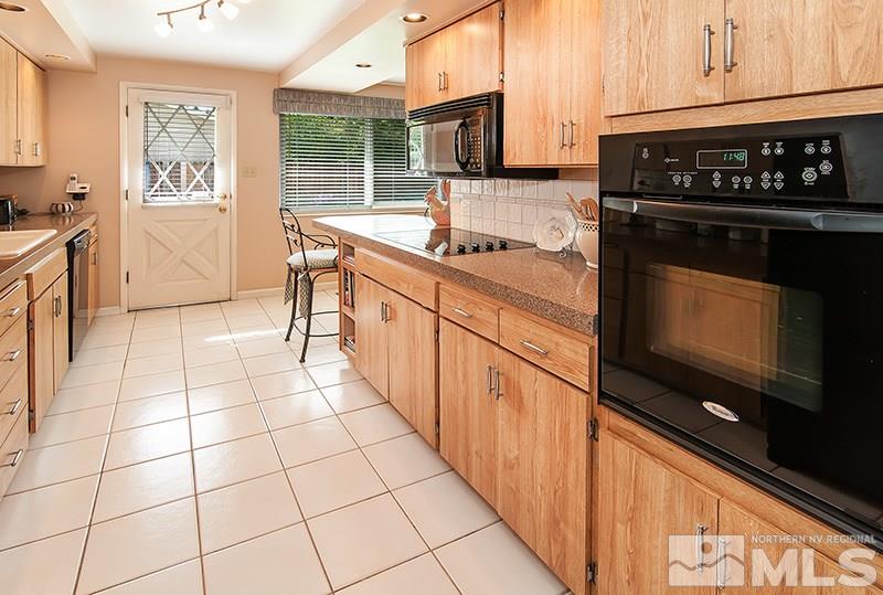 2520 Trentham Way Reno, NV 89509 - Photo 9 of 16 a kitchen with stainless steel appliances a sink stove and cabinets