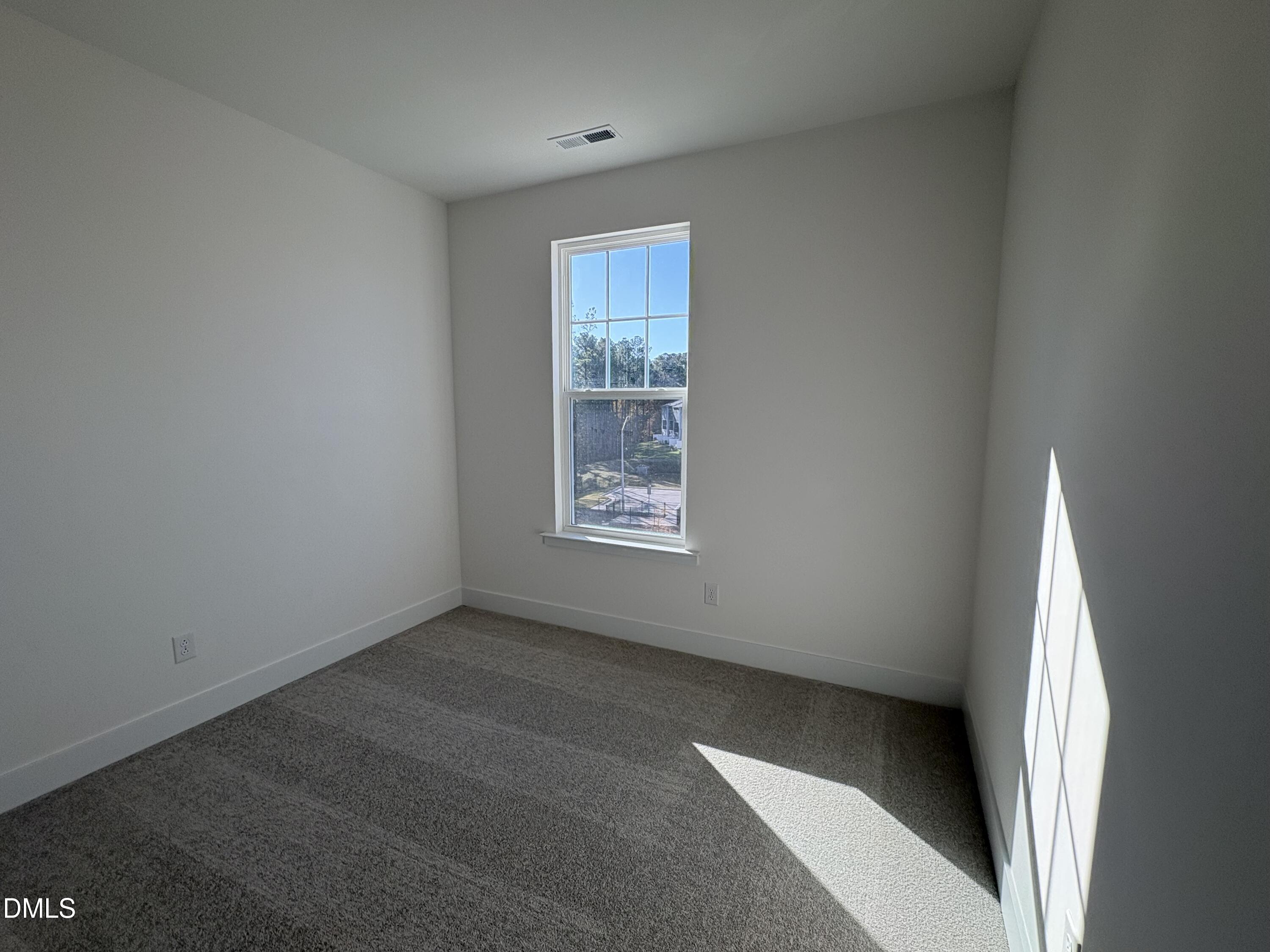 6046 Dunzo Drive Raleigh, NC 27617 - Photo 13 of 44 an empty room with windows