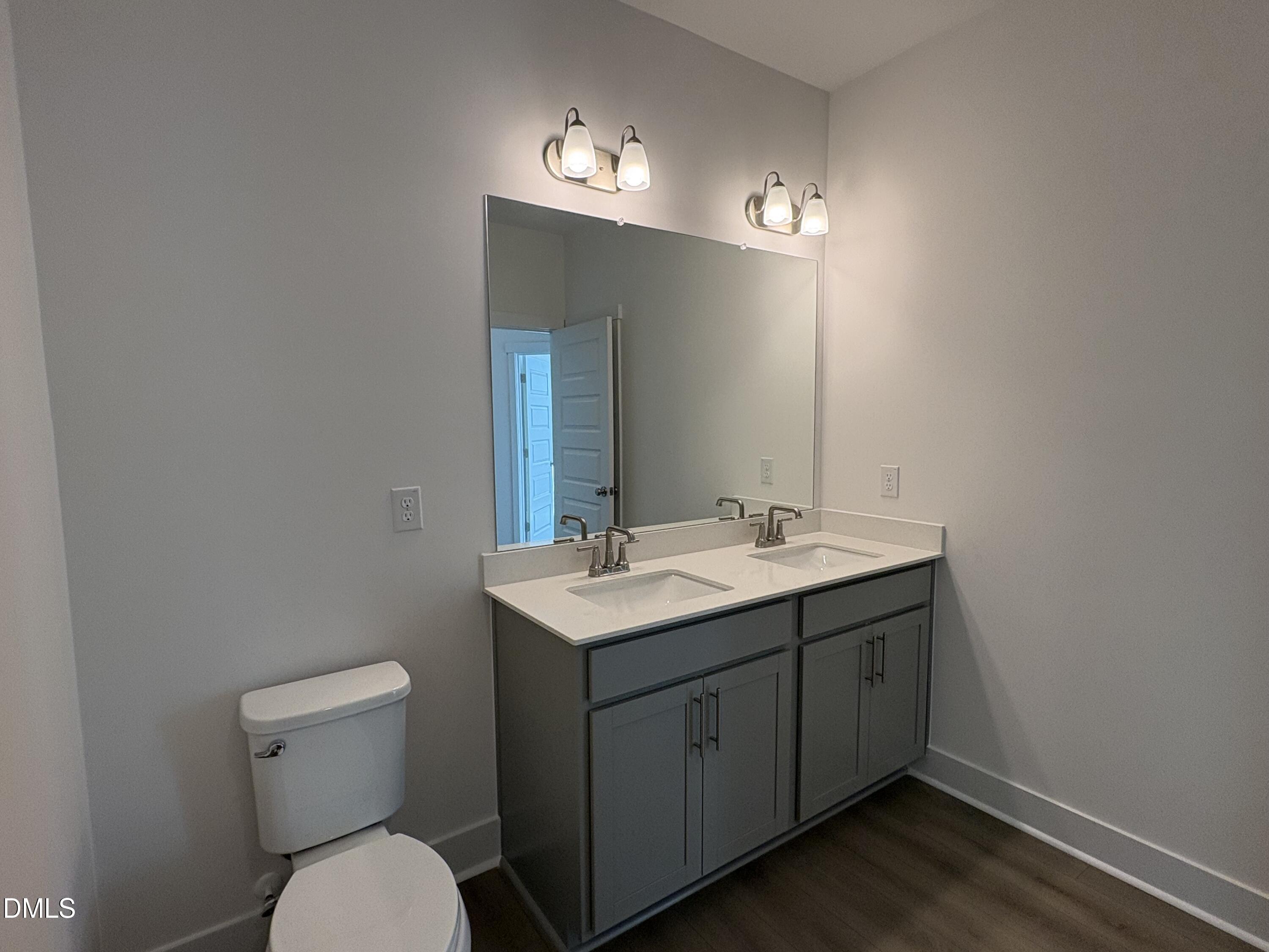 6046 Dunzo Drive Raleigh, NC 27617 - Photo 14 of 44 a bathroom with a toilet sink and mirror