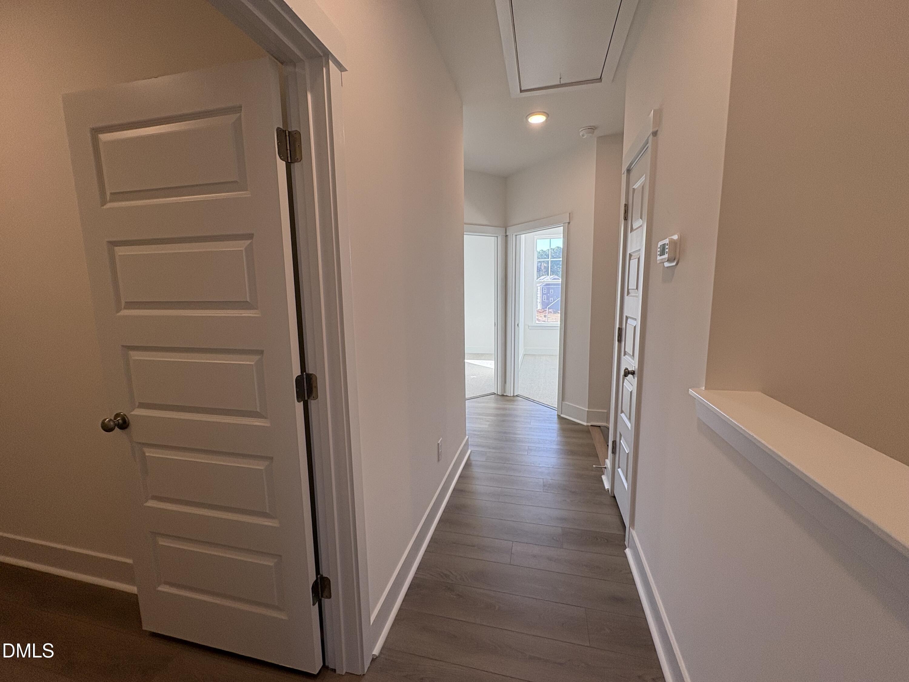6046 Dunzo Drive Raleigh, NC 27617 - Photo 16 of 44 a view of a hallway with wooden floor