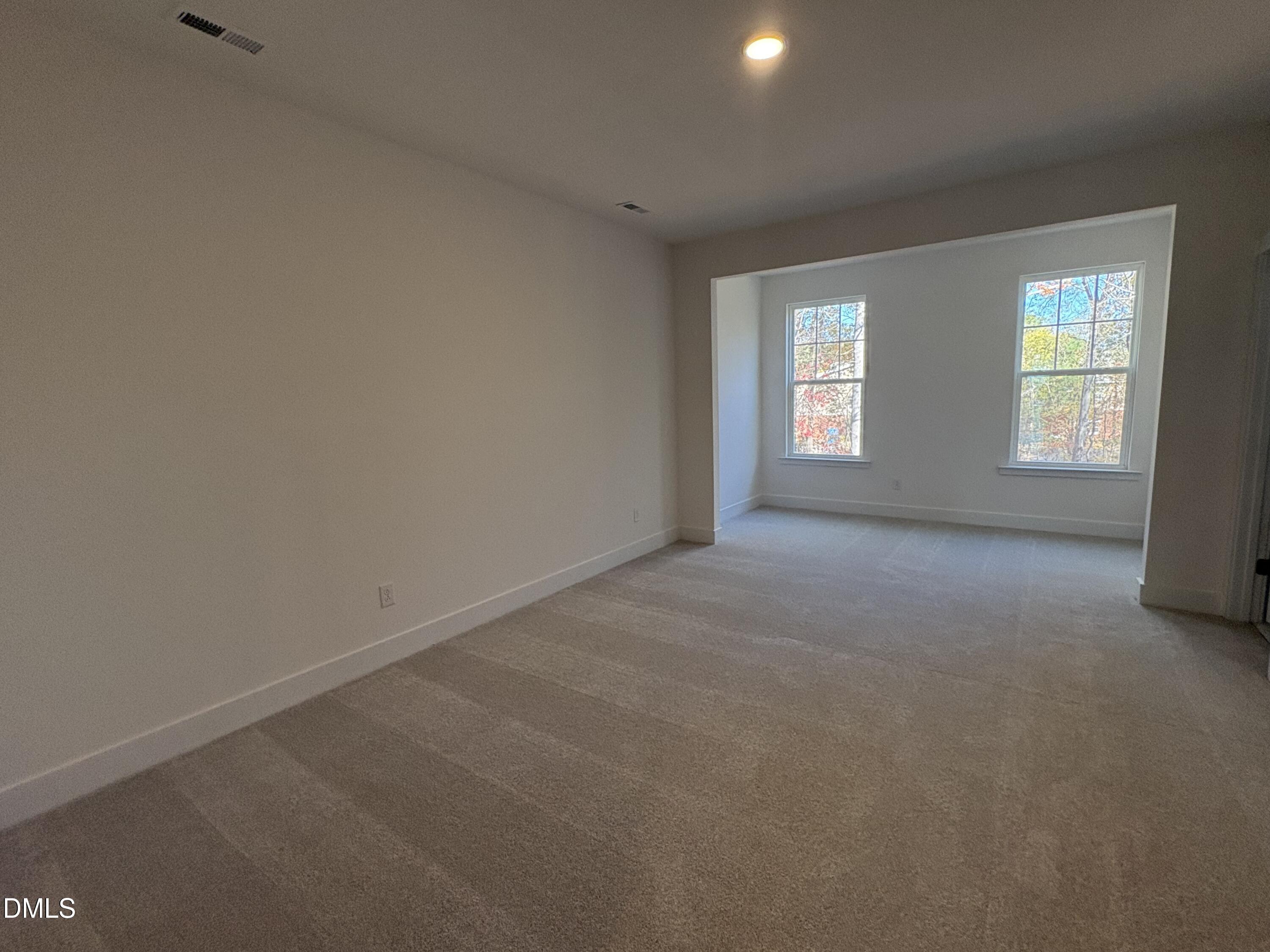 6046 Dunzo Drive Raleigh, NC 27617 - Photo 17 of 44 an empty room with windows