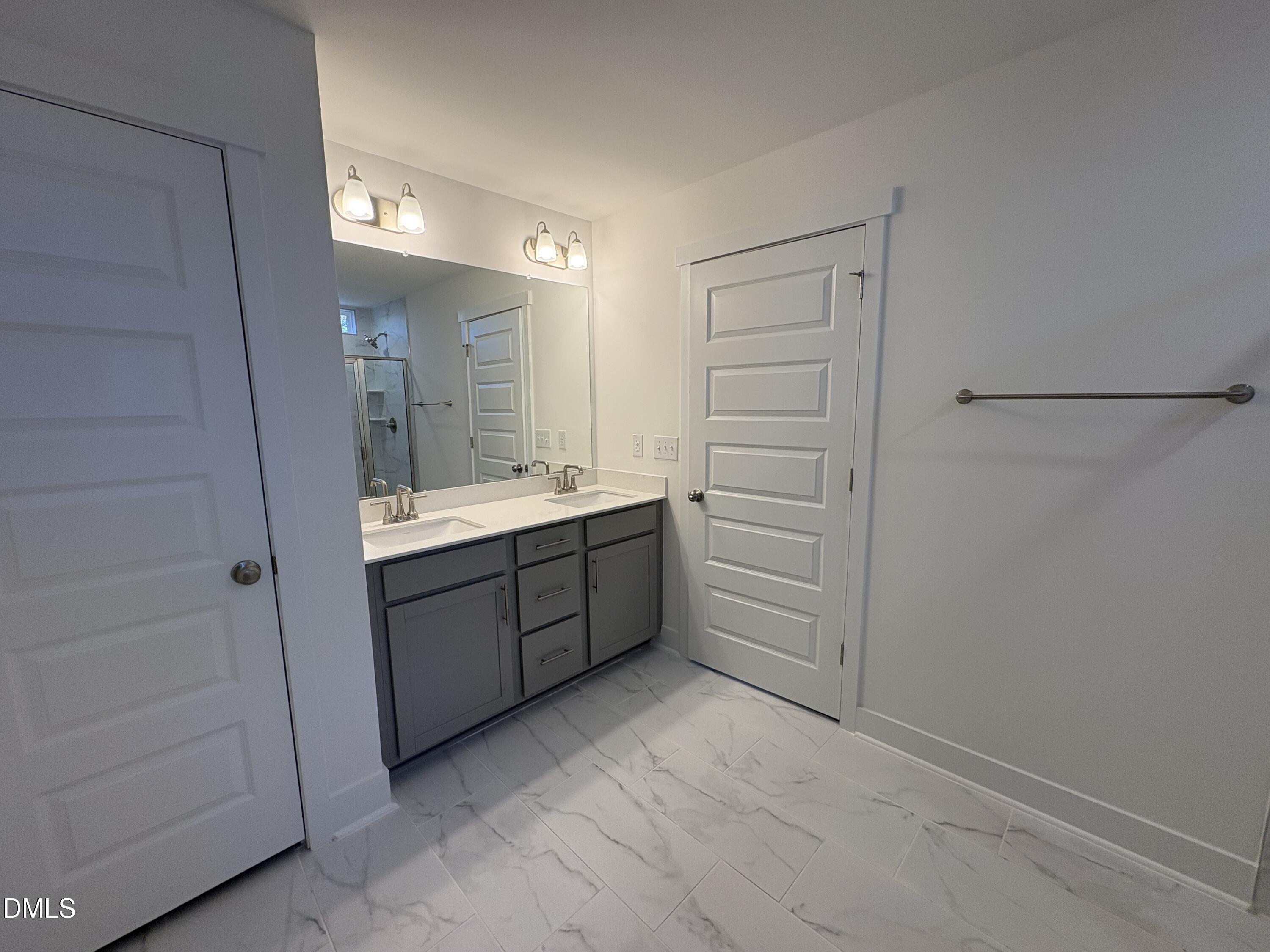 6046 Dunzo Drive Raleigh, NC 27617 - Photo 18 of 44 a room with a closet and a sink