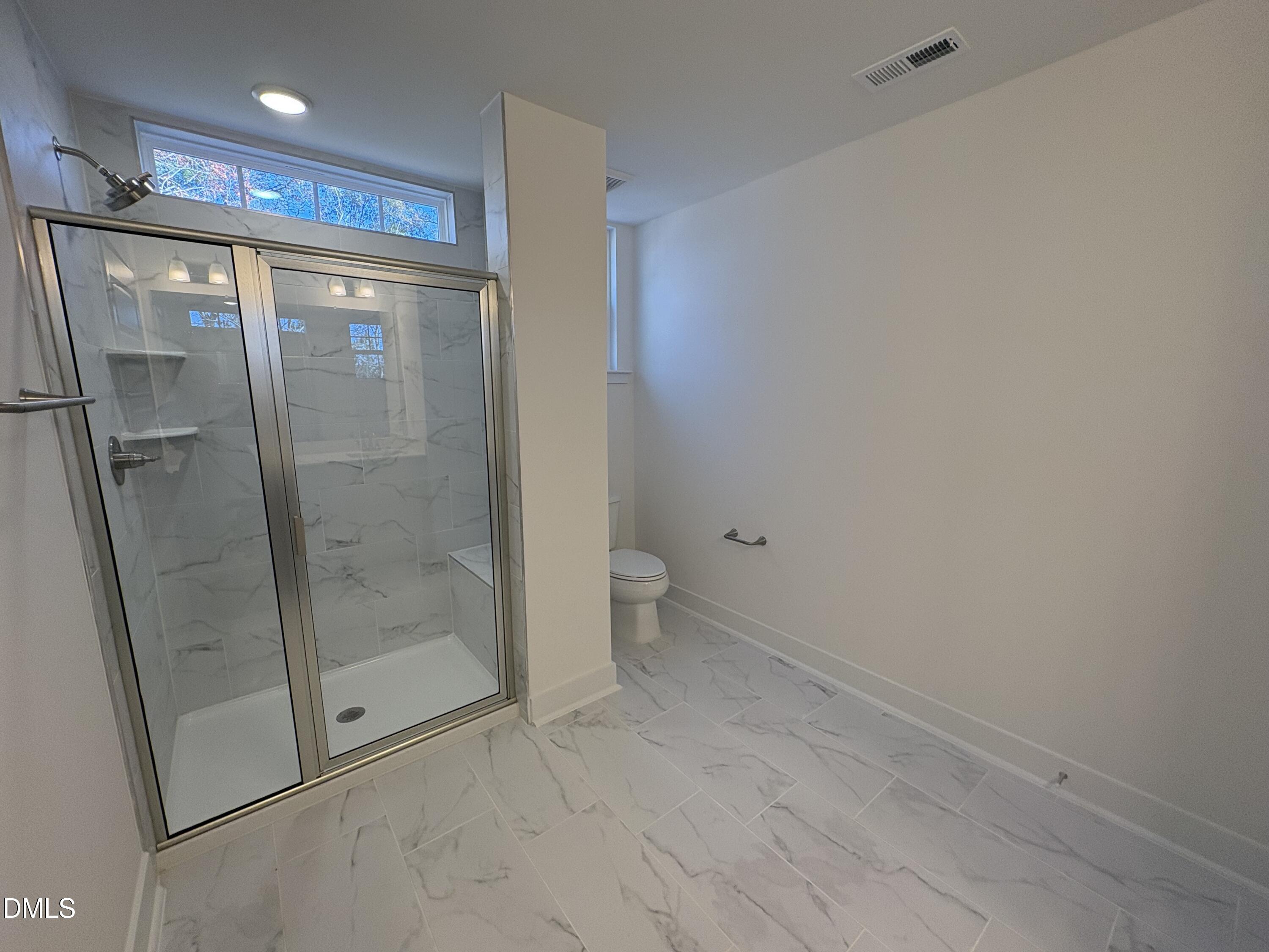 6046 Dunzo Drive Raleigh, NC 27617 - Photo 19 of 44 a bathroom with a shower and toilet