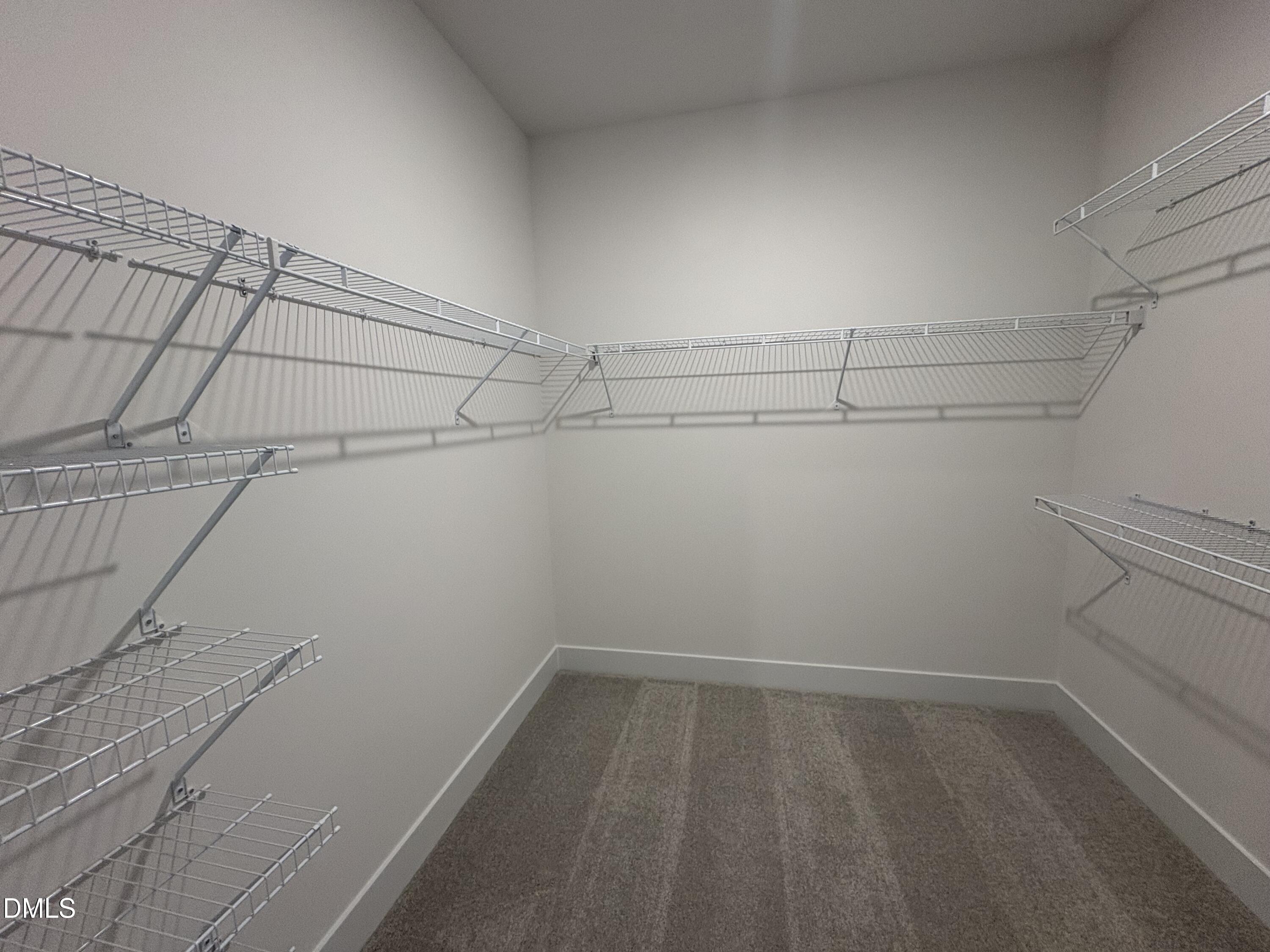 6046 Dunzo Drive Raleigh, NC 27617 - Photo 20 of 44 a view of a room with racks on the wall