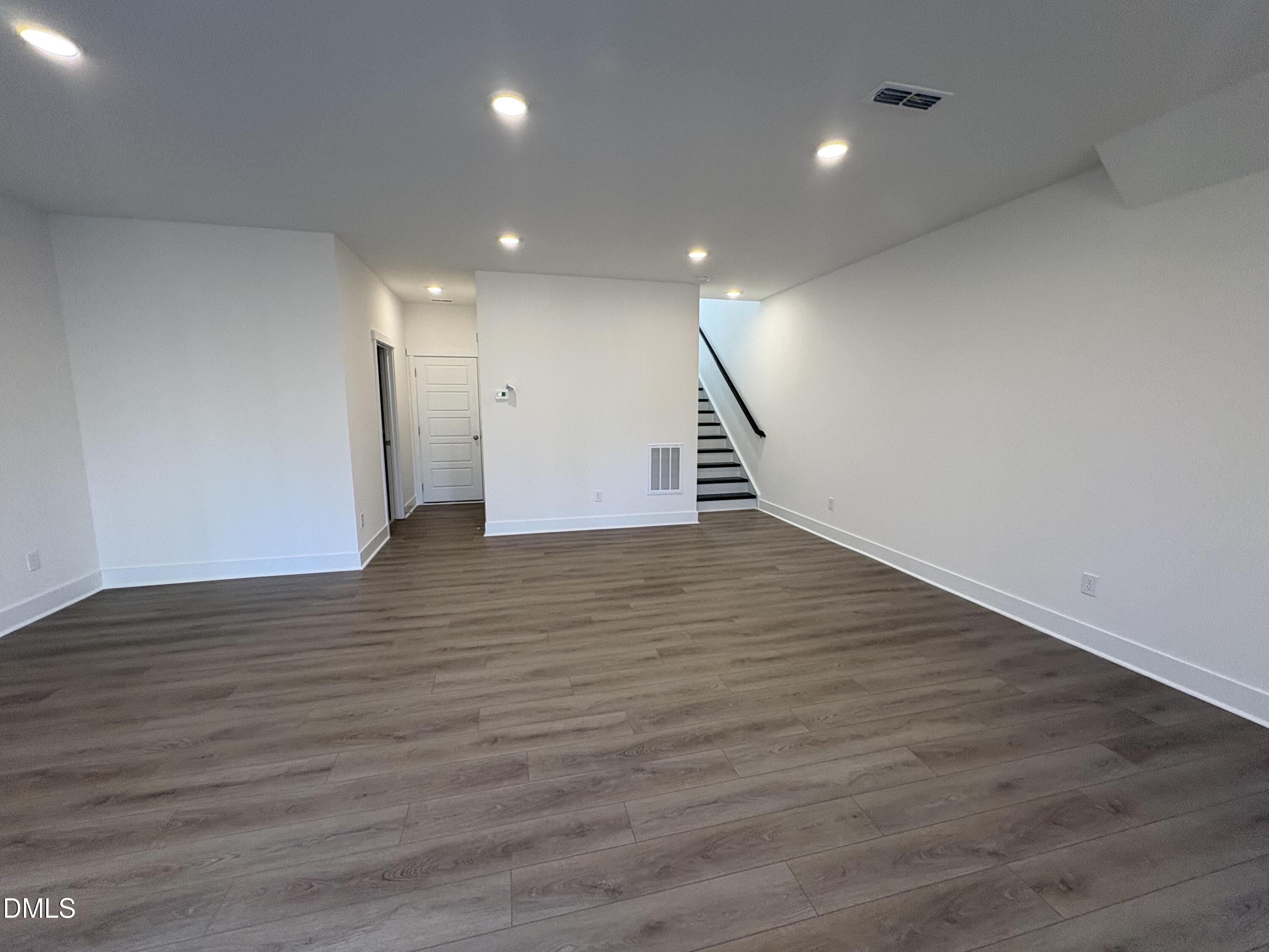 6046 Dunzo Drive Raleigh, NC 27617 - Photo 21 of 44 a view of an empty room with wooden floor