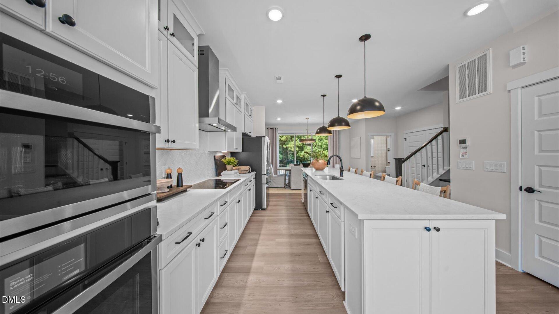 6046 Dunzo Drive Raleigh, NC 27617 - Photo 27 of 44 a large kitchen with white cabinets
